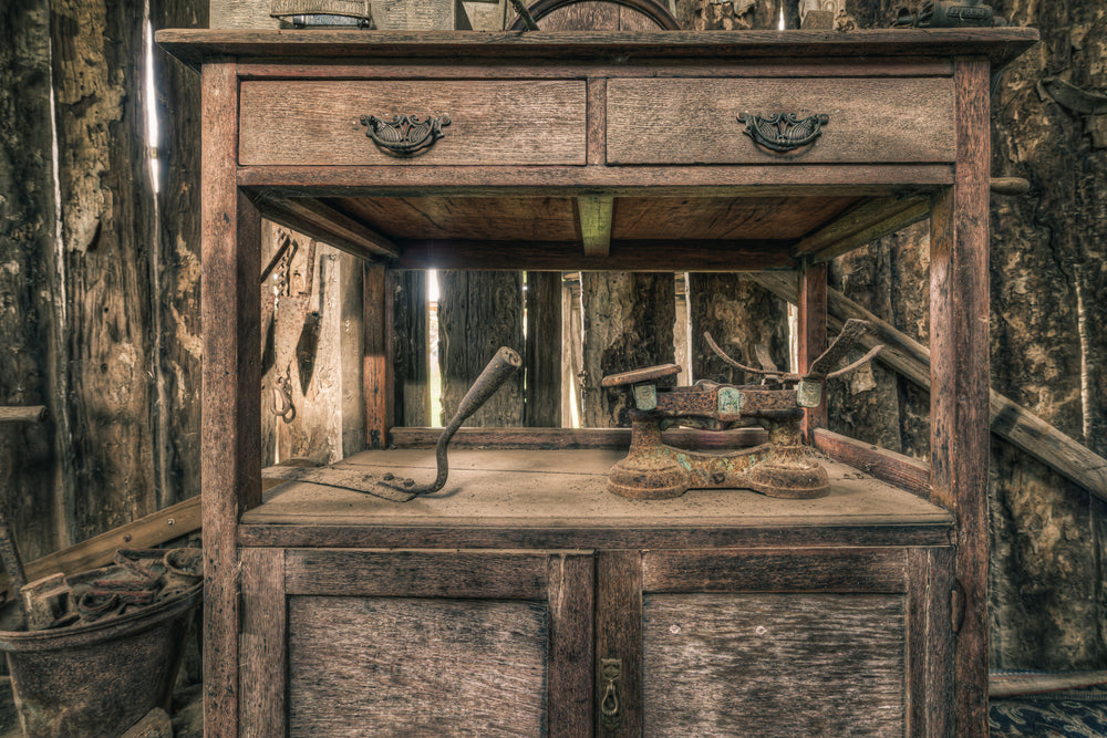 Scales at Leichhardt House, a hardwood washstand sits against a wall of peeling bark and rough-sawn timber.