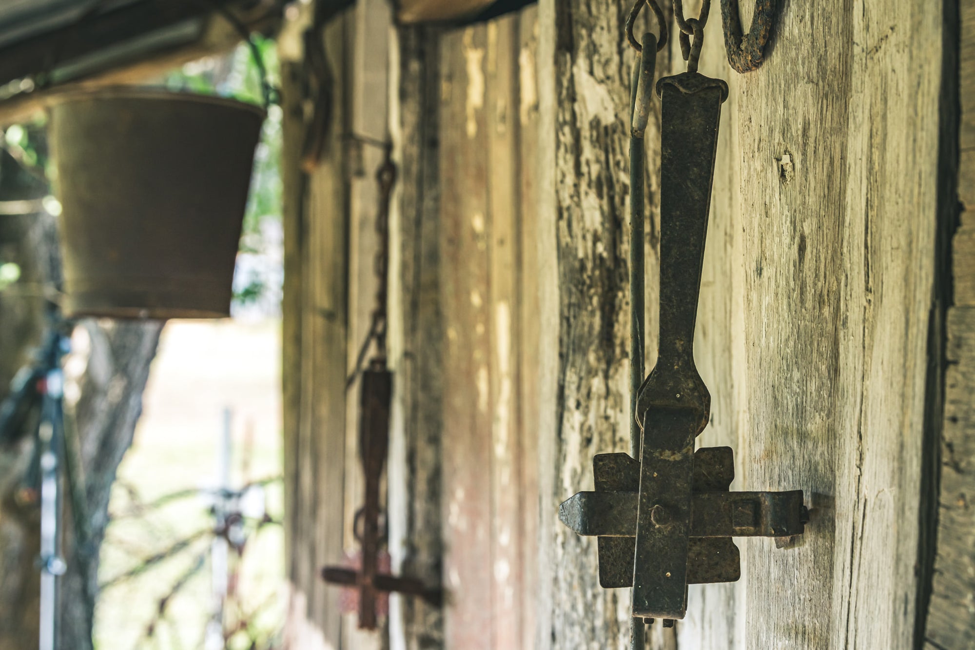 Traps at Leichhardt House, cast iron branding irons hang from hooks driven into weathered hardwood cladding.