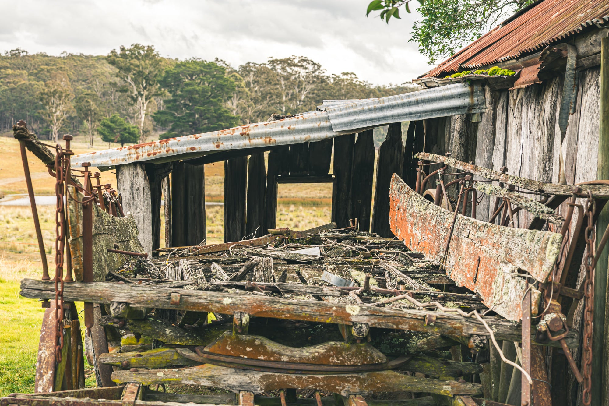 Wagon Tray at Leichhardt House, a horse-drawn wagon sits collapsed beside a slab timber shed.