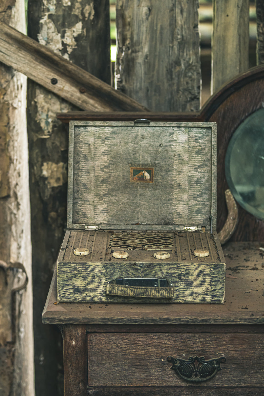 Wireless Front On at Leichhardt House, a portable valve radio sits open on a timber dresser, its lid propped back to reveal.