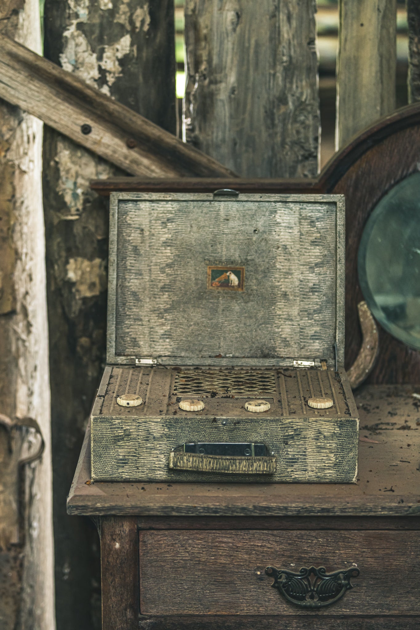 Wireless Front On at Leichhardt House, a portable valve radio sits open on a timber dresser, its lid propped back to reveal.