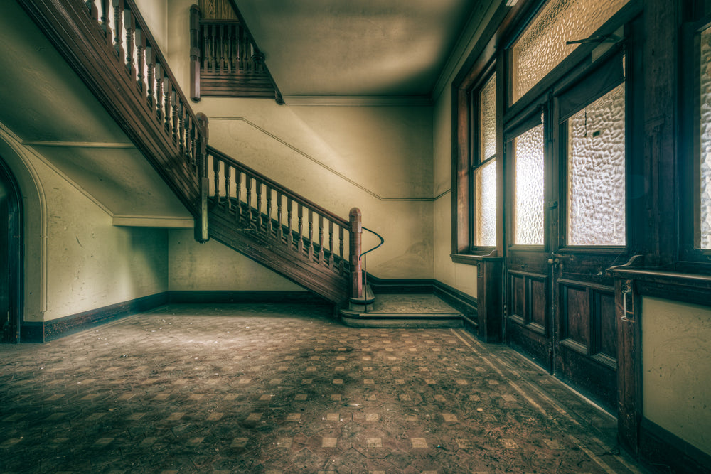 Foyer Stairs at Lewisham Hospital, a dark timber staircase climbs from the foyer, its turned balusters still intact.