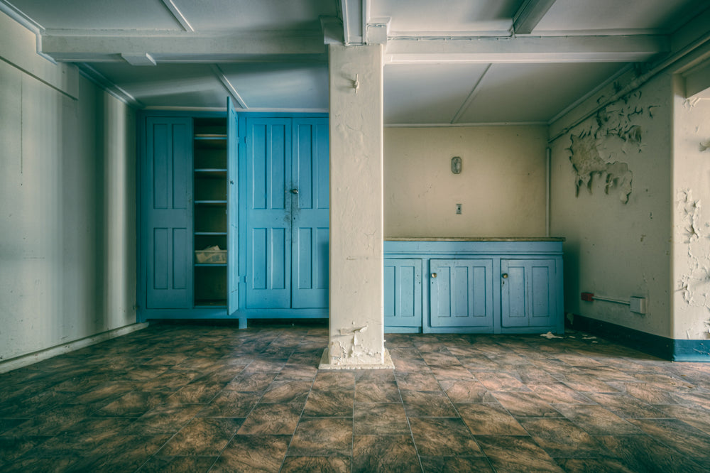 Nurses Lunch Room at Lewisham Hospital, blue panelled cabinetry lines two walls of a basement-level room.