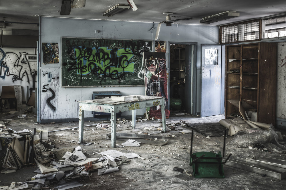 Art Room at Macquarie Boys Technology High, a teacher's desk stands centre-room, its white paint chipped and dull.