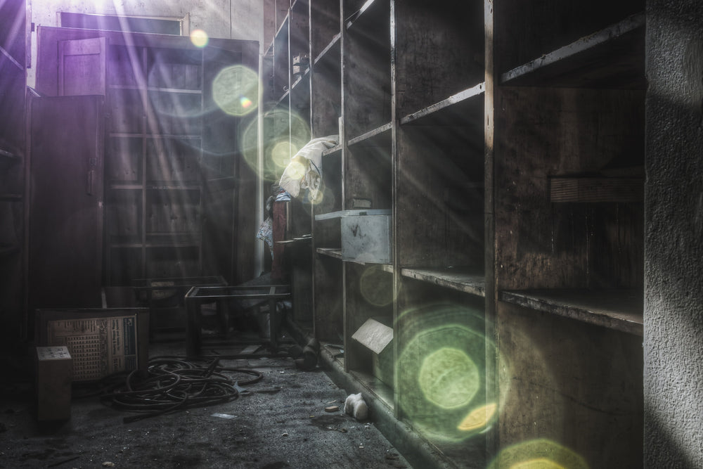 Art Storage at Macquarie Boys Technology High, a sun flare cuts through the darkness of this storage room.