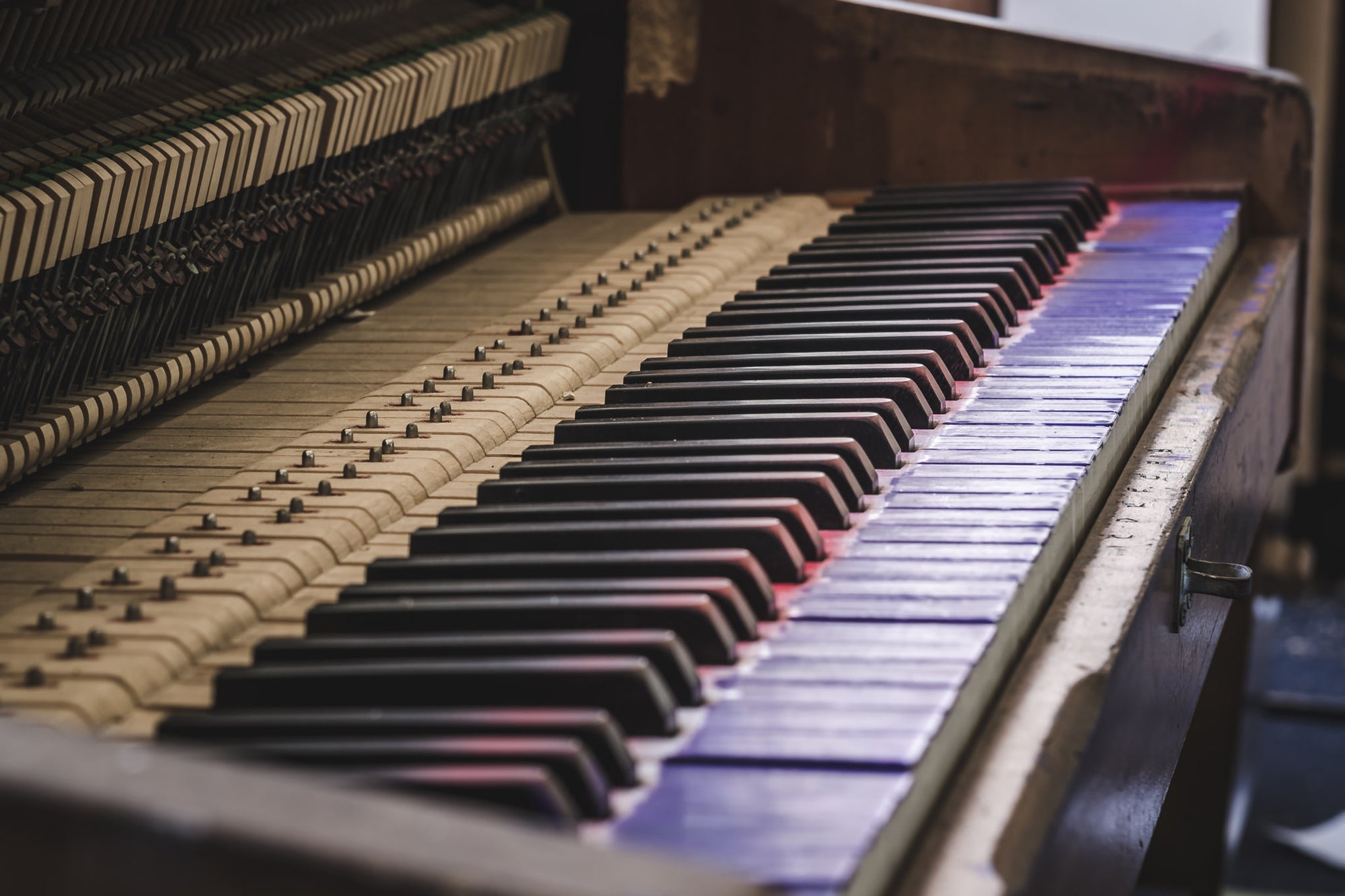 Piano at Macquarie Boys Technology High, an upright piano sits with its front panel removed, exposing the full row.