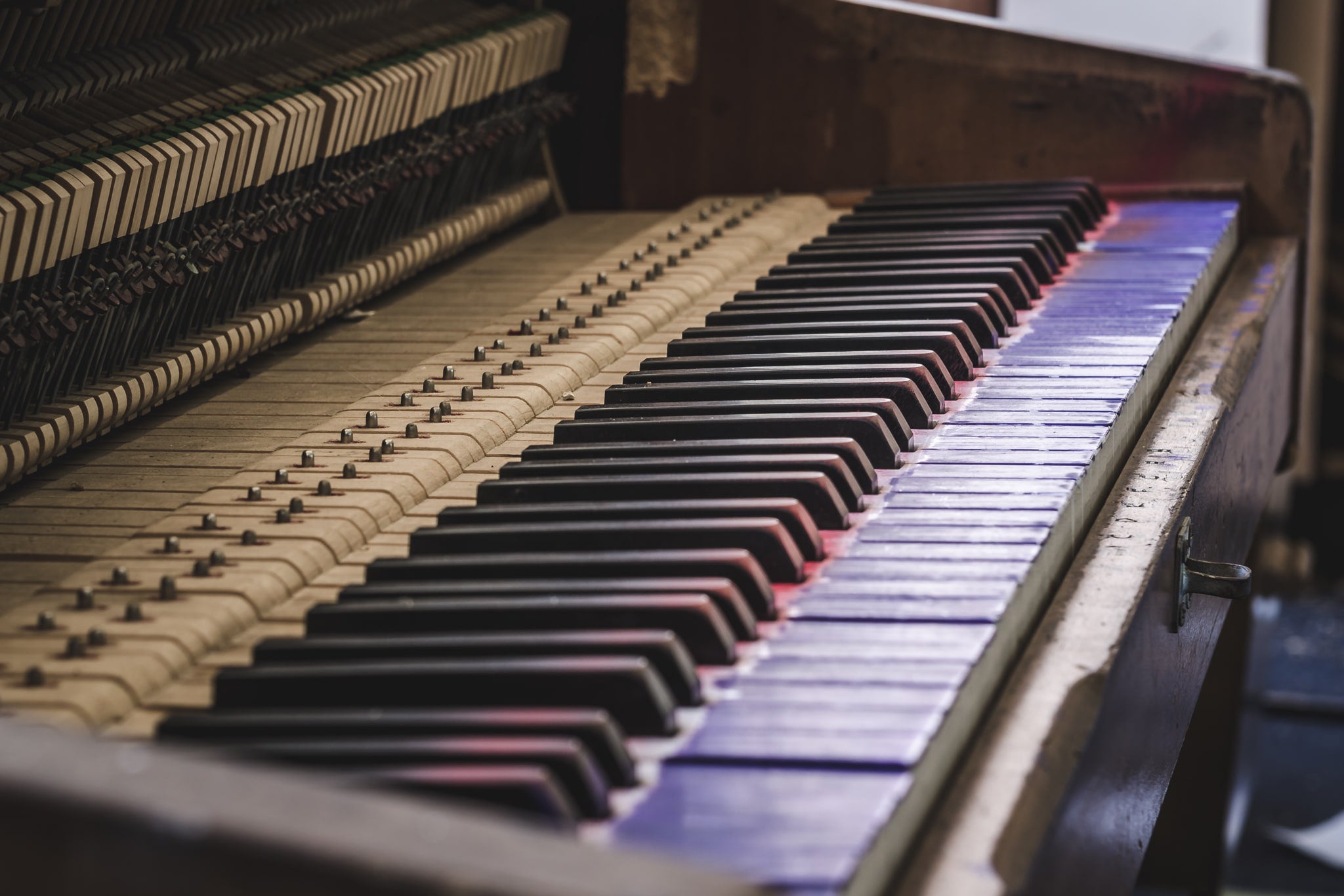 Piano at Macquarie Boys Technology High, an upright piano sits with its front panel removed, exposing the full row.