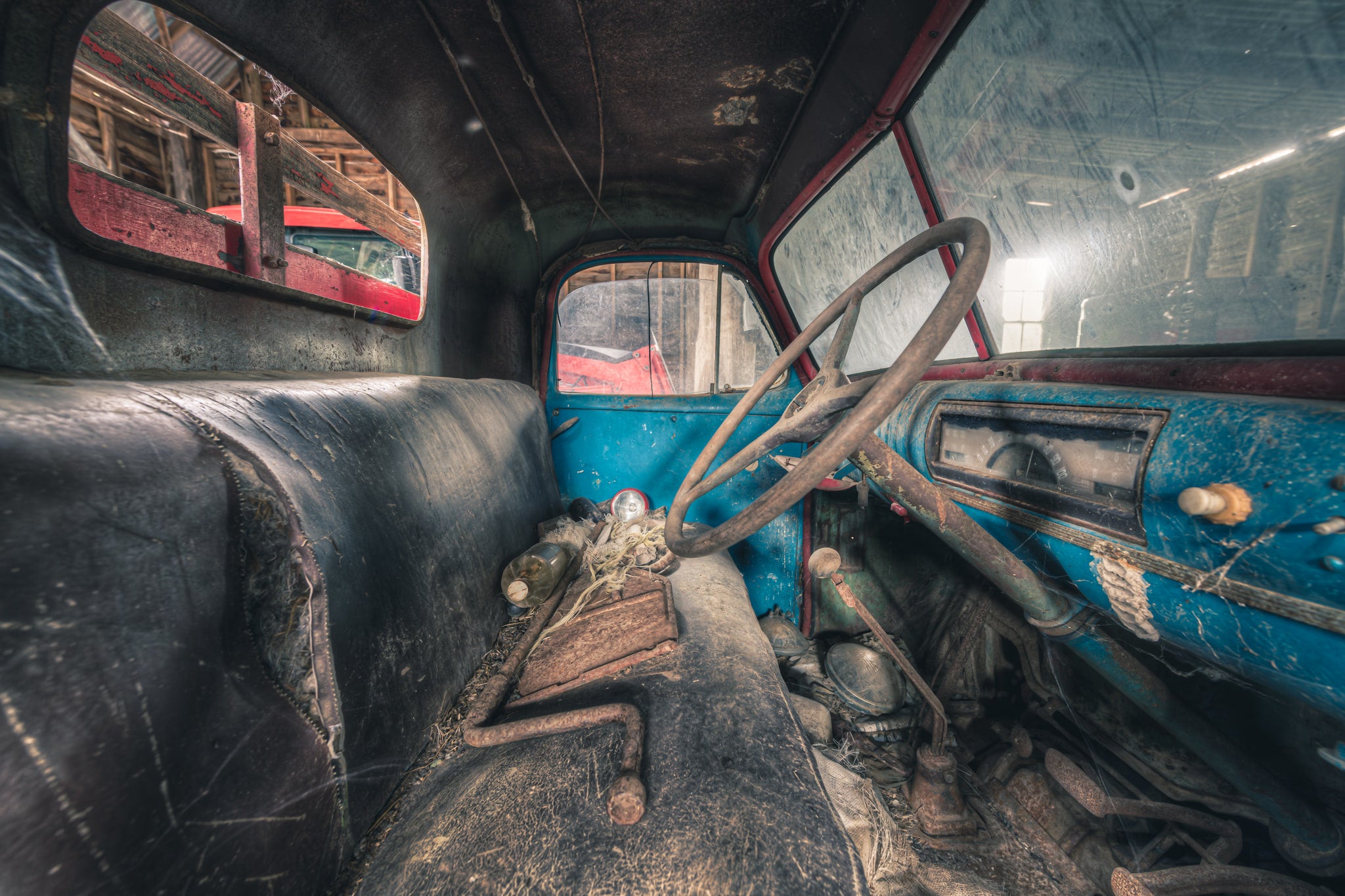 Take the Wheel at Mill Pond Farm, inside the cab of a mid-century truck, blue paint clings to the dashboard in uneven.