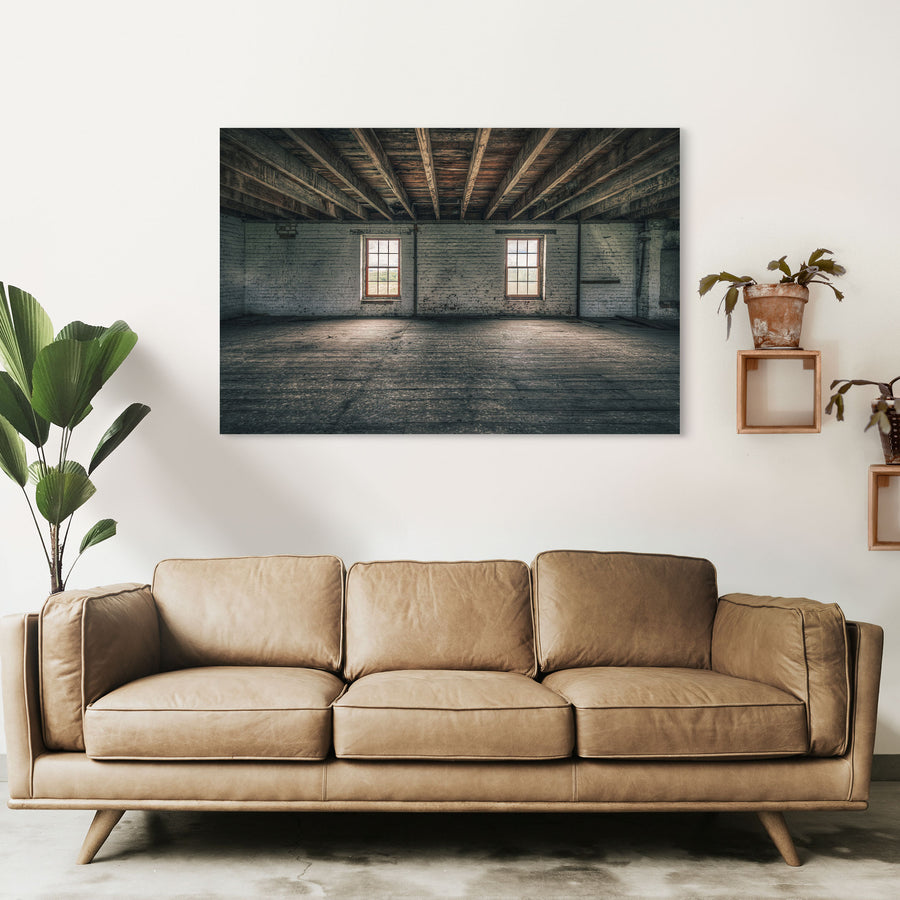 Upper room at Jembaicumbene grain store, two sash windows in a whitewashed brick wall under timber beams.