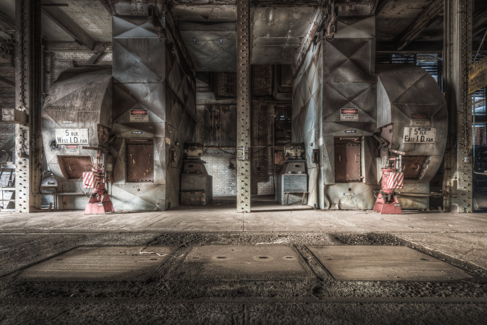 Blowers at Morwell Power Station, two induced-draft fans sit in mirrored bays either side of a riveted steel column.