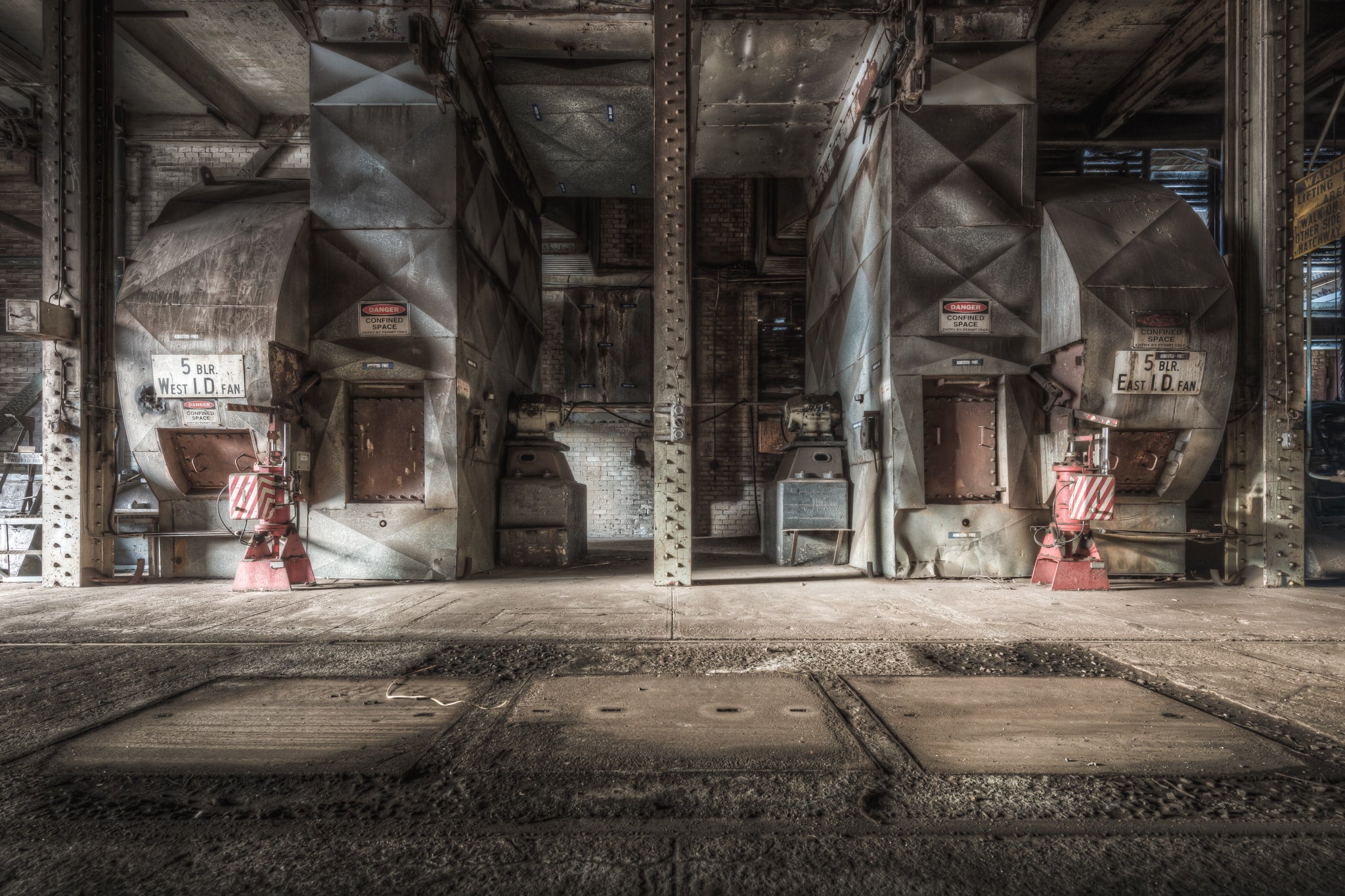 Blowers at Morwell Power Station, two induced-draft fans sit in mirrored bays either side of a riveted steel column.
