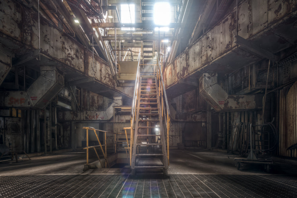 Boiler House 3 at Morwell Power Station, a steel staircase rises through the centre of the frame, climbing between two.