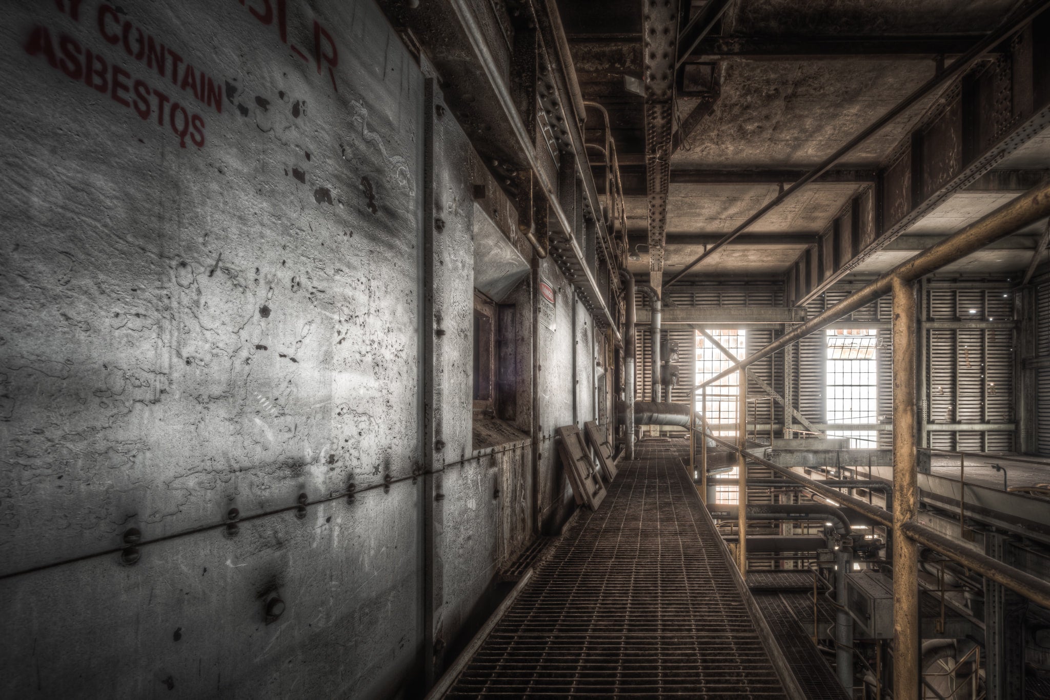 Boiler House at Morwell Power Station, a steel mesh walkway runs between concrete-clad boiler casings and a lattice of pipes.