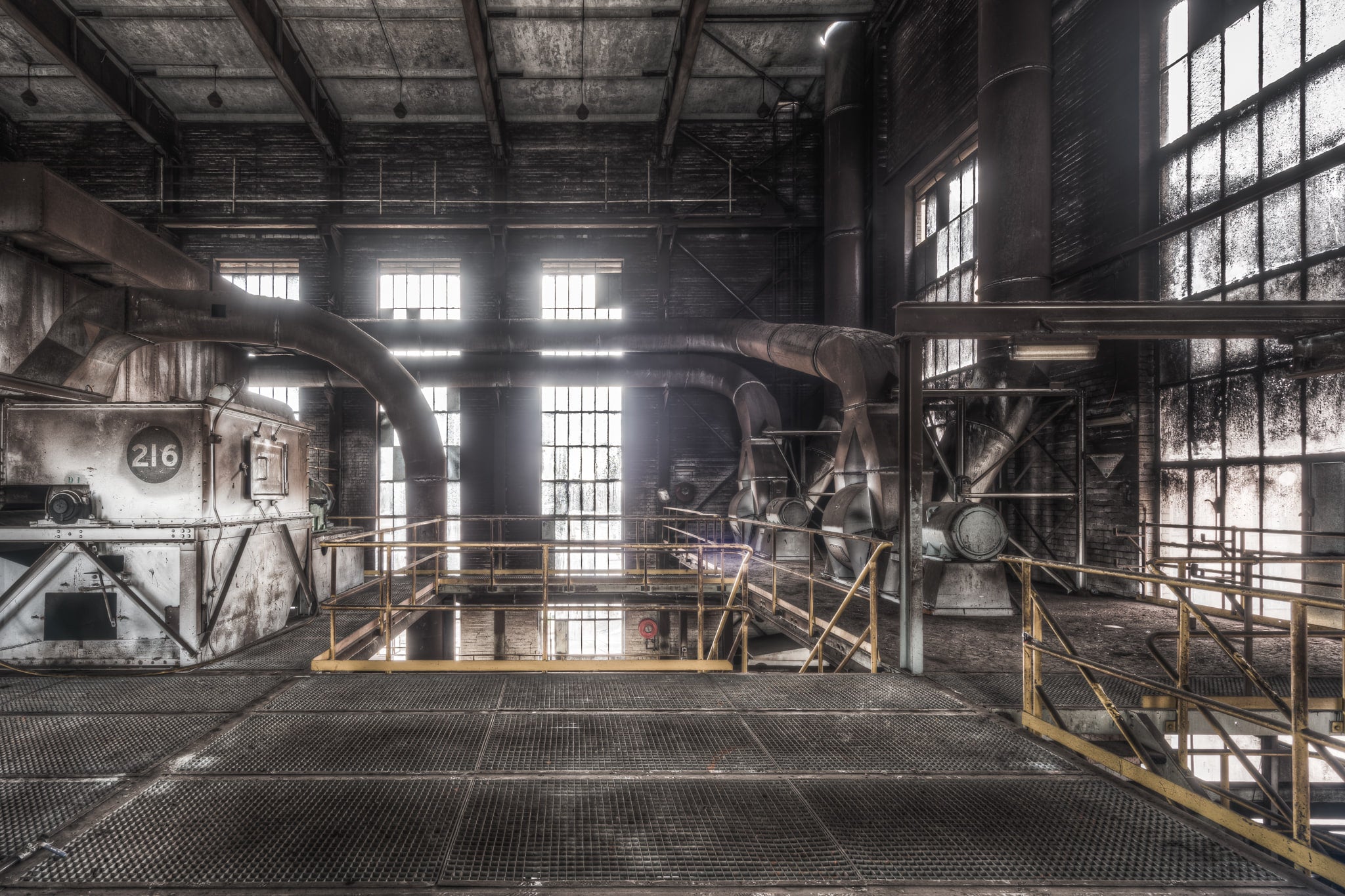 Dust Extraction at Morwell Power Station, steel grating covers the floor of the upper level, gridded and dark with decades.