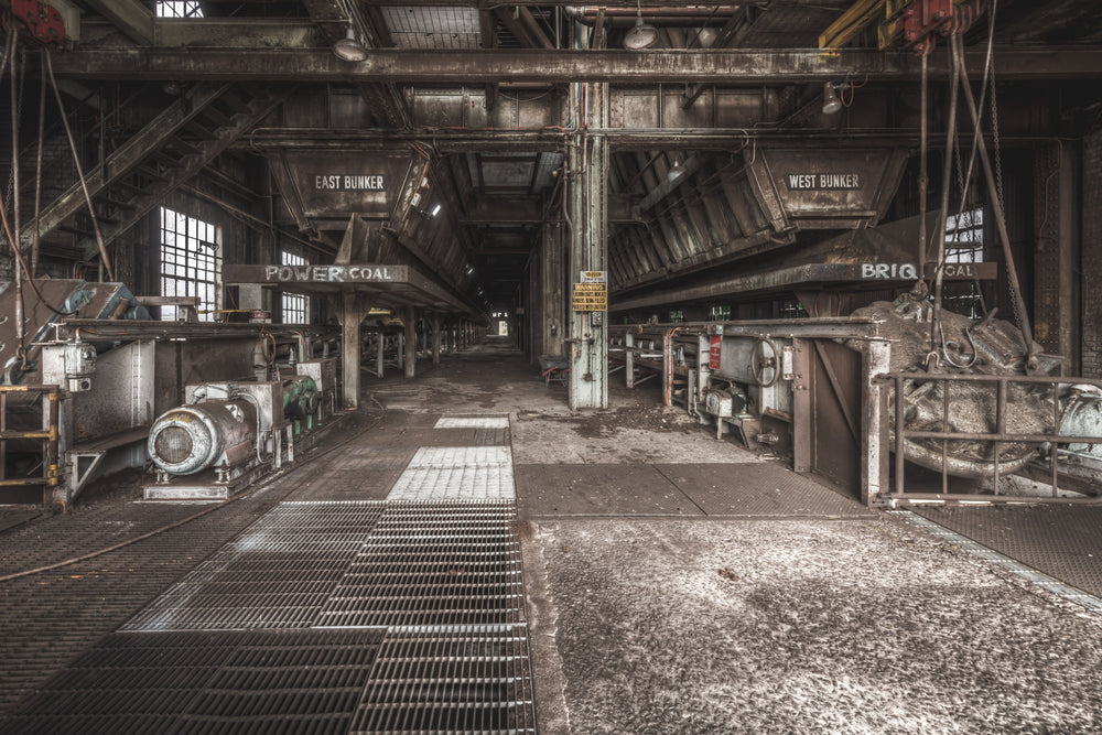 East and West at Morwell Power Station, steel coal bunkers hang overhead, labelled East and West.
