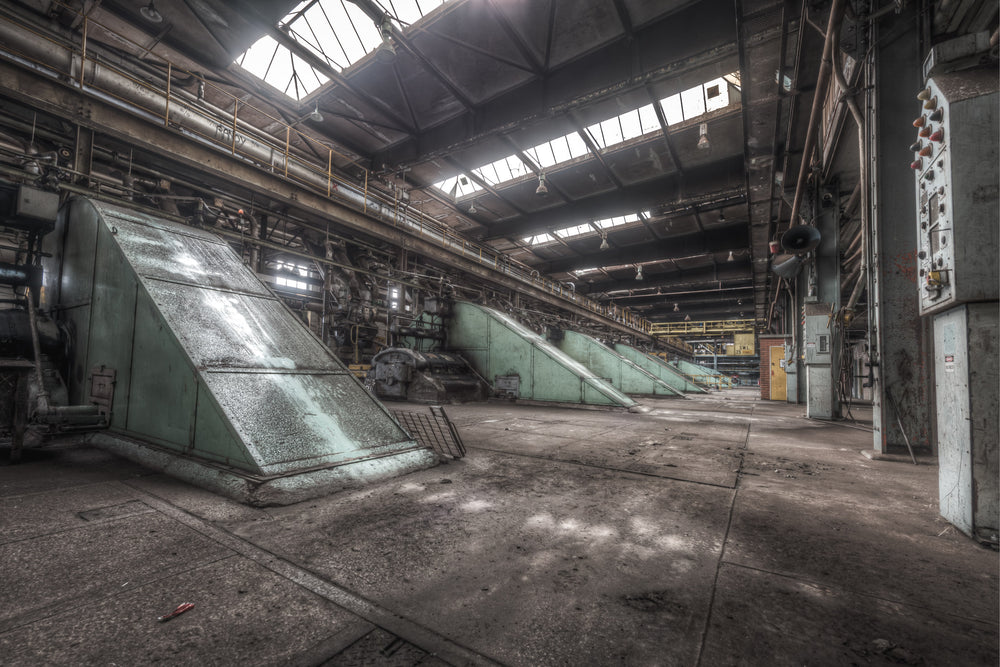 Main Press Floor at Morwell Power Station, large green steel housings sit at sharp angles along the concrete floor.