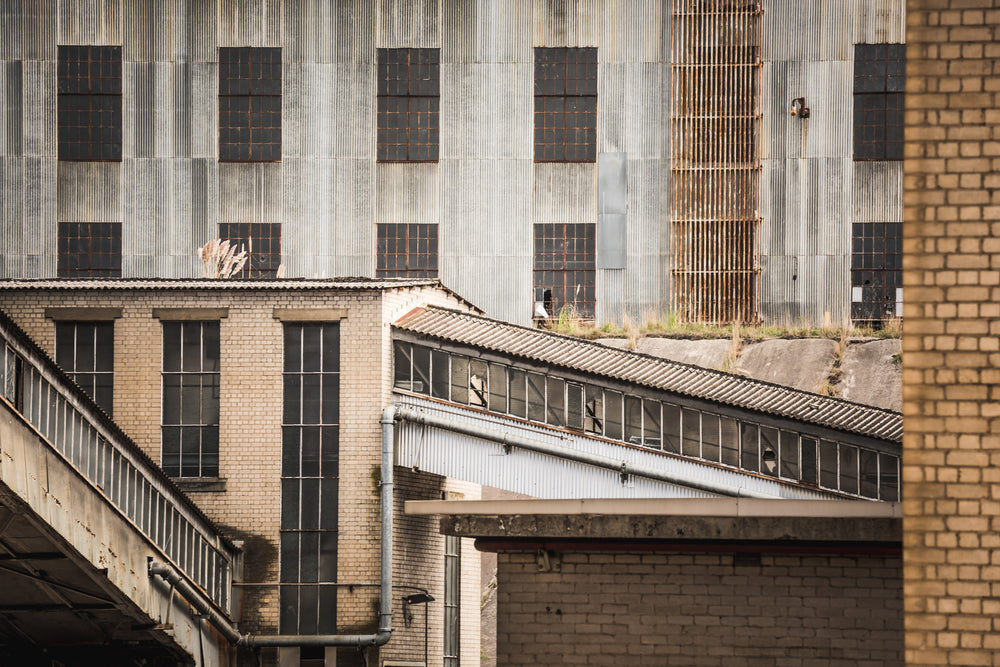 Maze at Morwell Power Station, cream brick and corrugated iron press tight against each other.