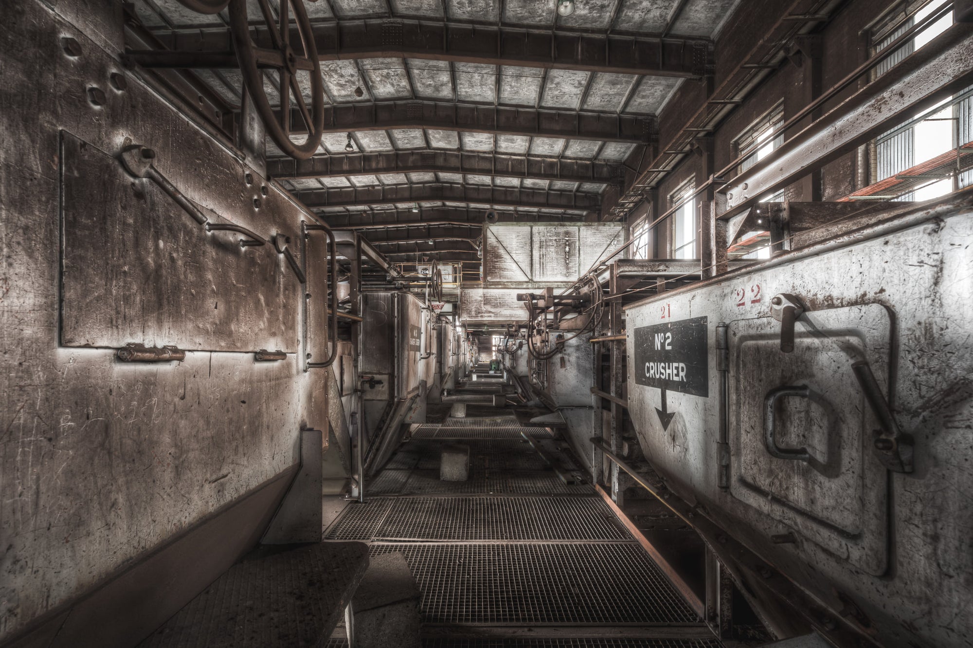 Number 2 Crusher at Morwell Power Station, a steel mesh walkway runs between two rows of crusher housings.