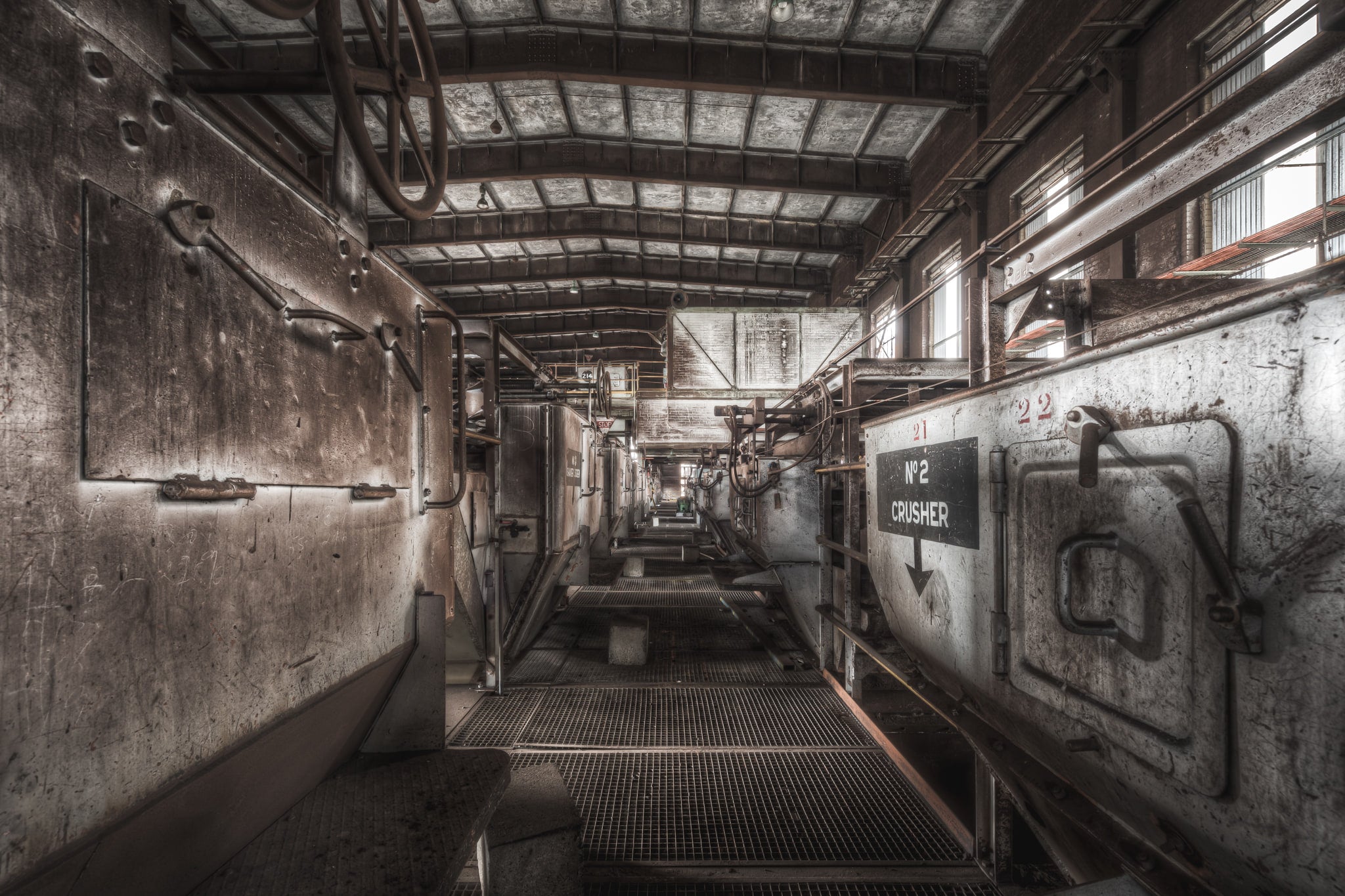 Number 2 Crusher at Morwell Power Station, a steel mesh walkway runs between two rows of crusher housings.