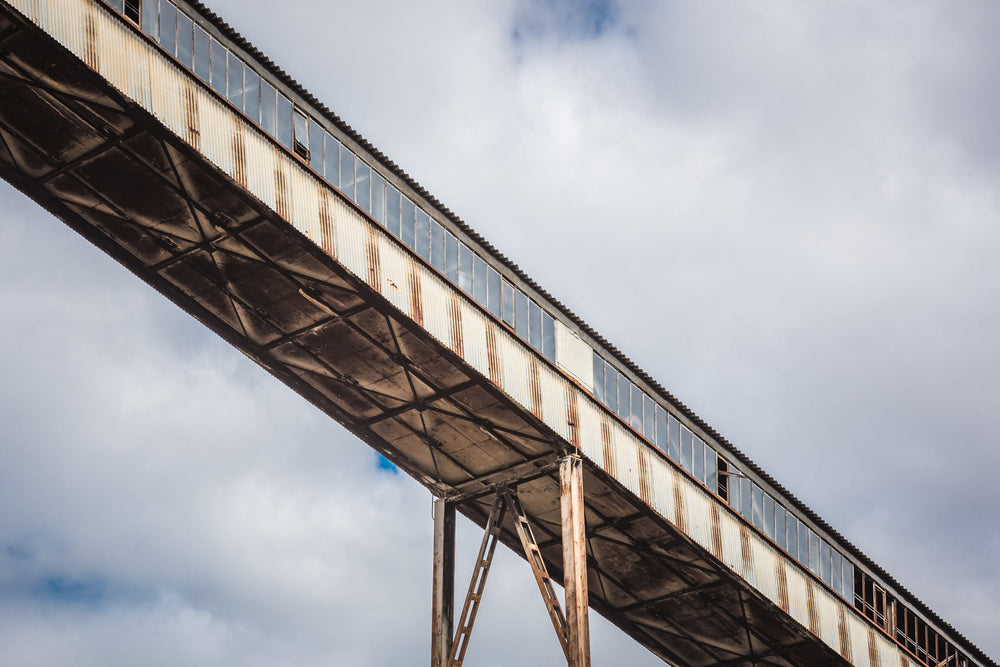 Point to Point at Morwell Power Station, an enclosed conveyor bridge cuts diagonally across an overcast sky, supported.
