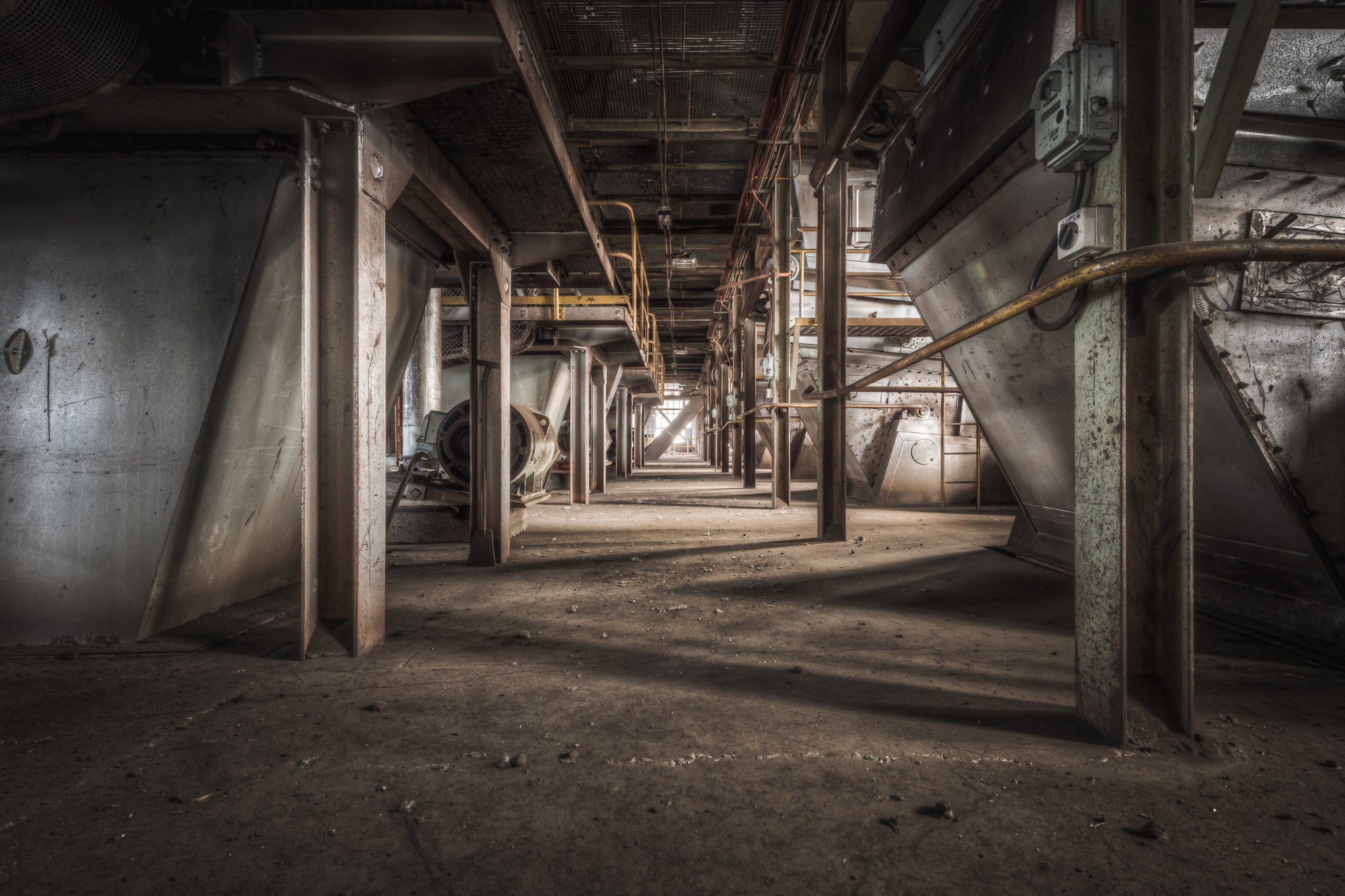 Screen Floor at Morwell Power Station, steel hoppers line both sides of a narrow corridor, their conical bases suspended.