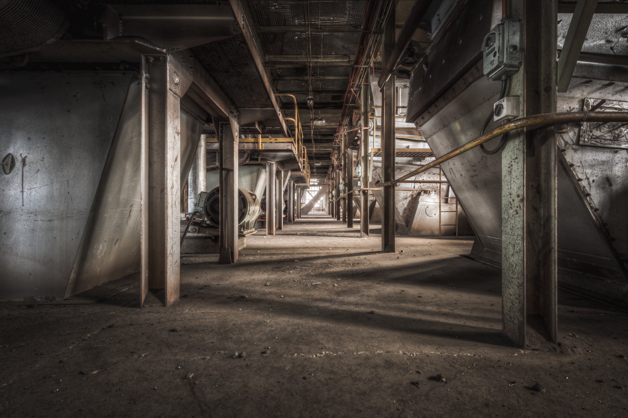 Screen Floor at Morwell Power Station, steel hoppers line both sides of a narrow corridor, their conical bases suspended.