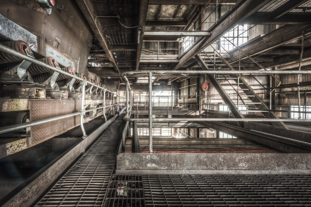 Shuttle Conveyor at Morwell Power Station, a steel grating walkway runs alongside a heavy conveyor system deep inside.