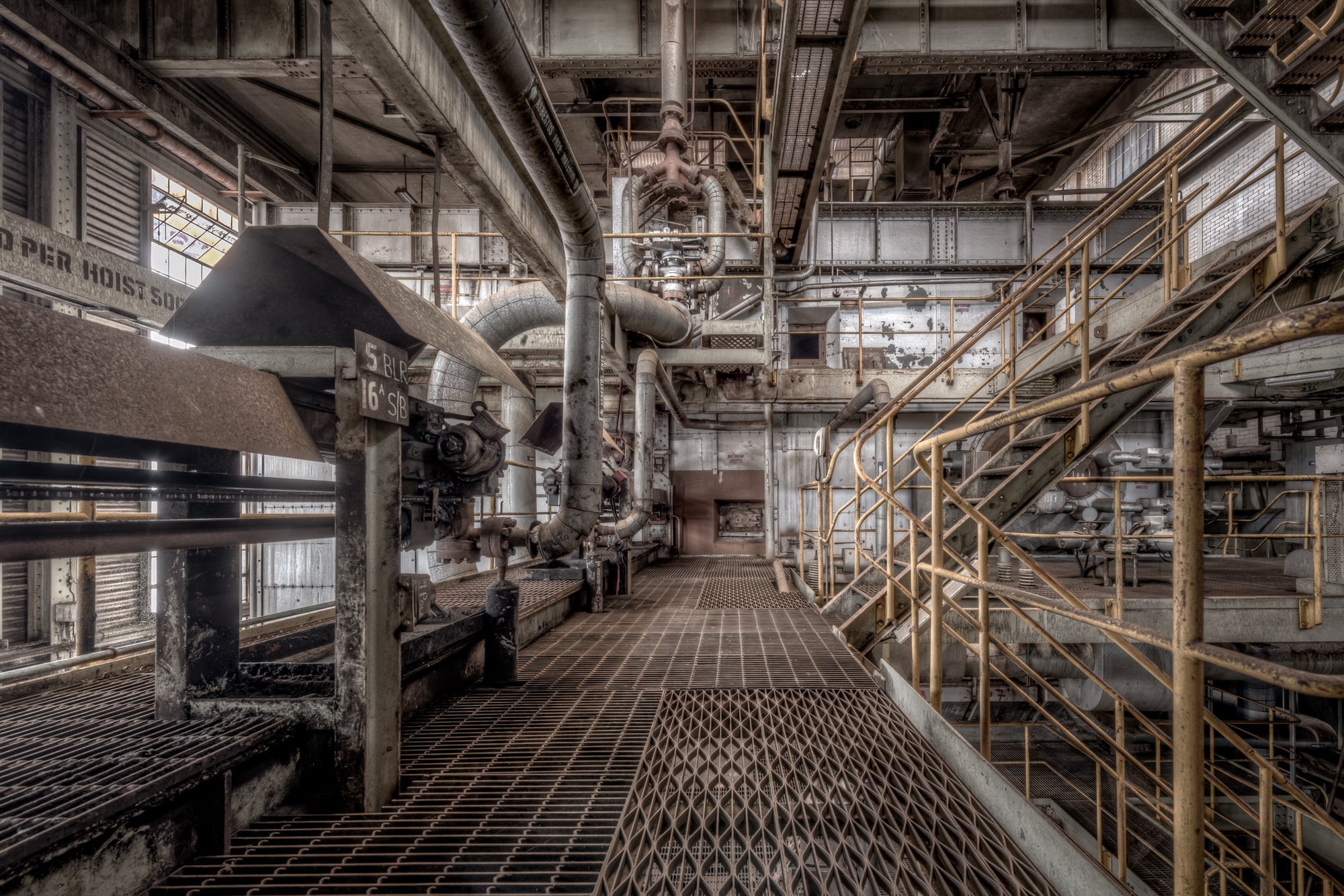 Soot Blower at Morwell Power Station, steel grating stretches down a narrow service walkway between boiler units.