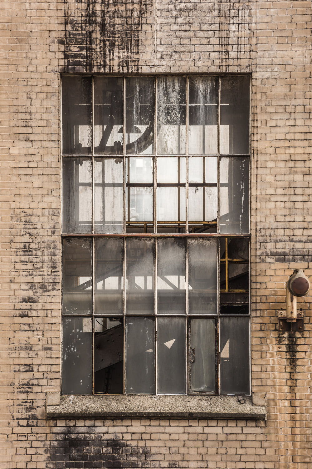 Transfer House at Morwell Power Station, cream brick facade, blackened where water has tracked down from the roofline.