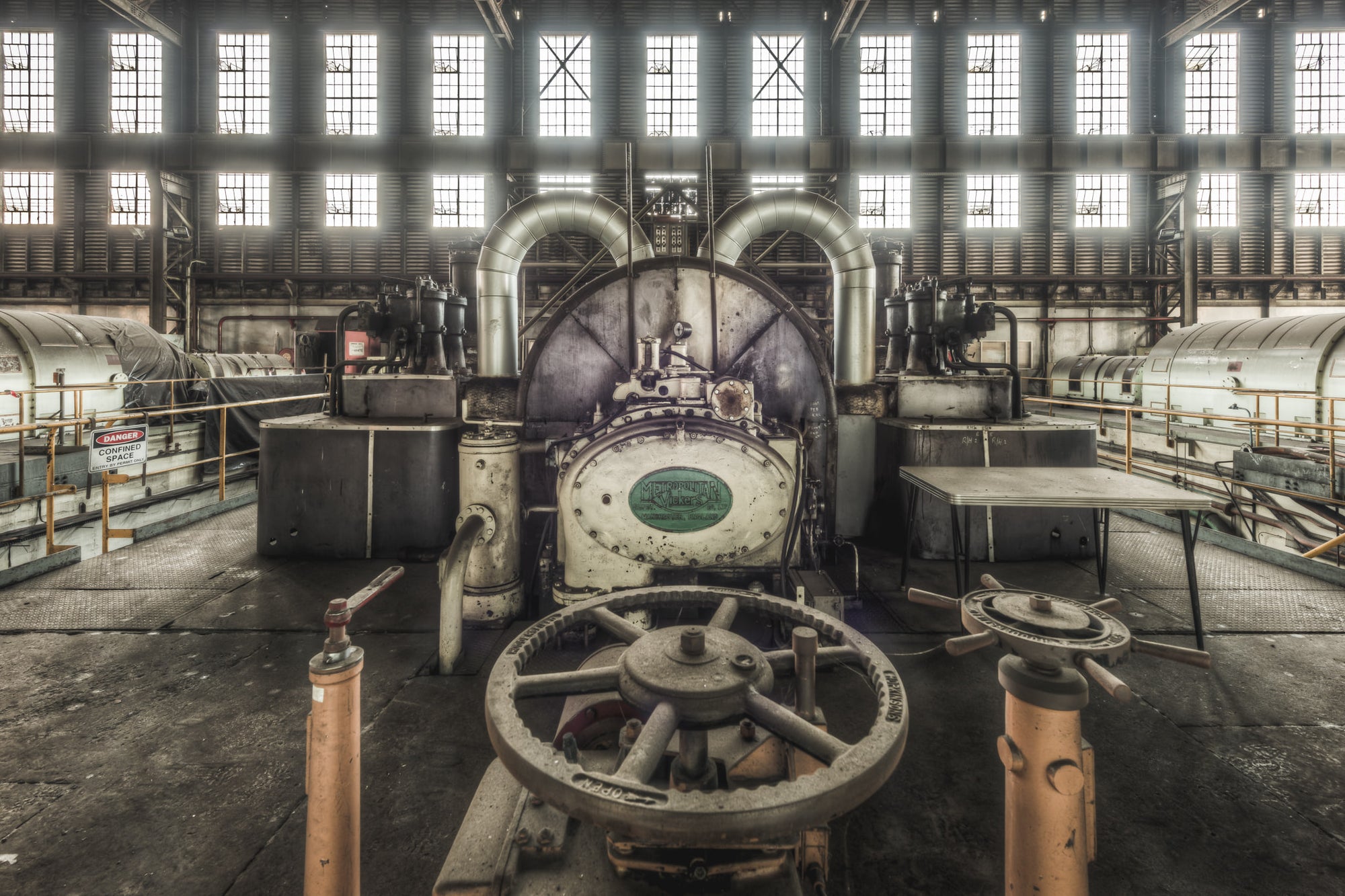 Turbine Front at Morwell Power Station, a heavy cast-iron valve wheel sits in the foreground, its spokes thick with dust.
