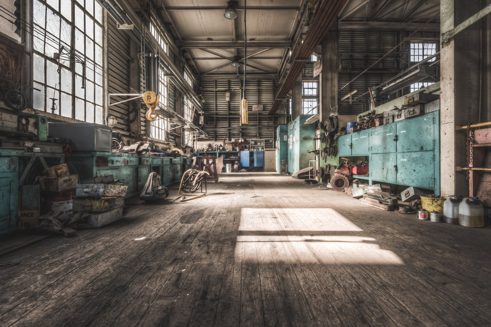 Workshop at Morwell Power Station, a rectangle of sunlight falls across worn timber floorboards inside the maintenance.