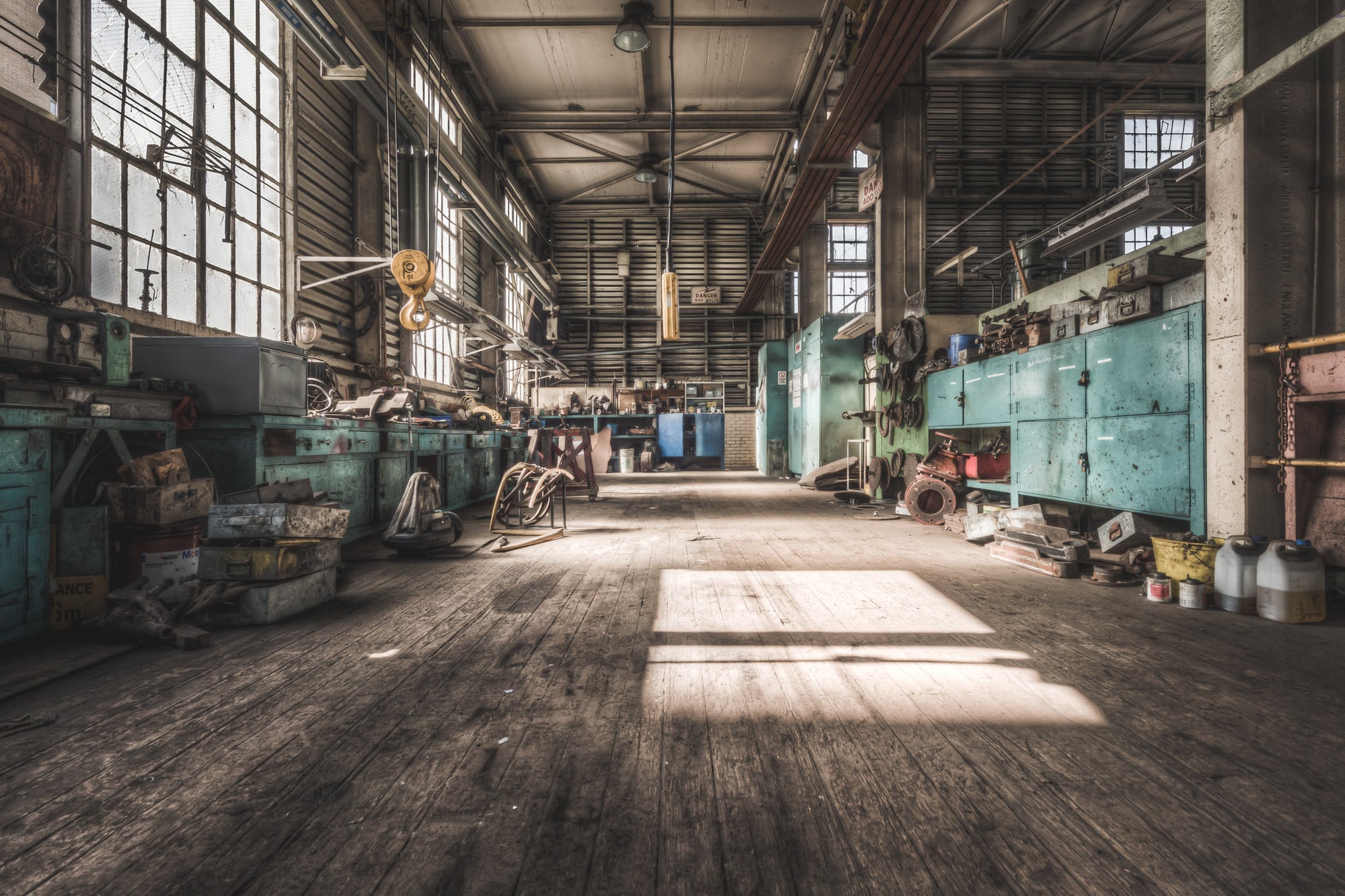 Workshop at Morwell Power Station, a rectangle of sunlight falls across worn timber floorboards inside the maintenance.