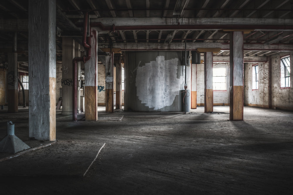 Pylons at Mungo Scott Flour Mill, two rows of massive wooden pylons within the mill building with the diagonally laid.