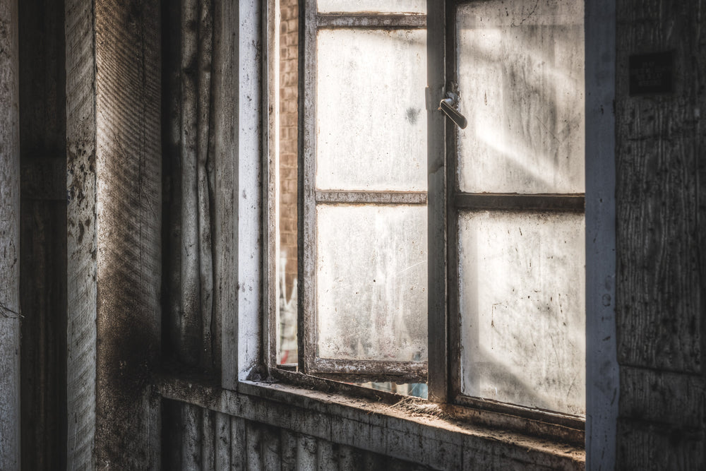 Window at Mungo Scott Flour Mill, a dusty window inside the flour mill.