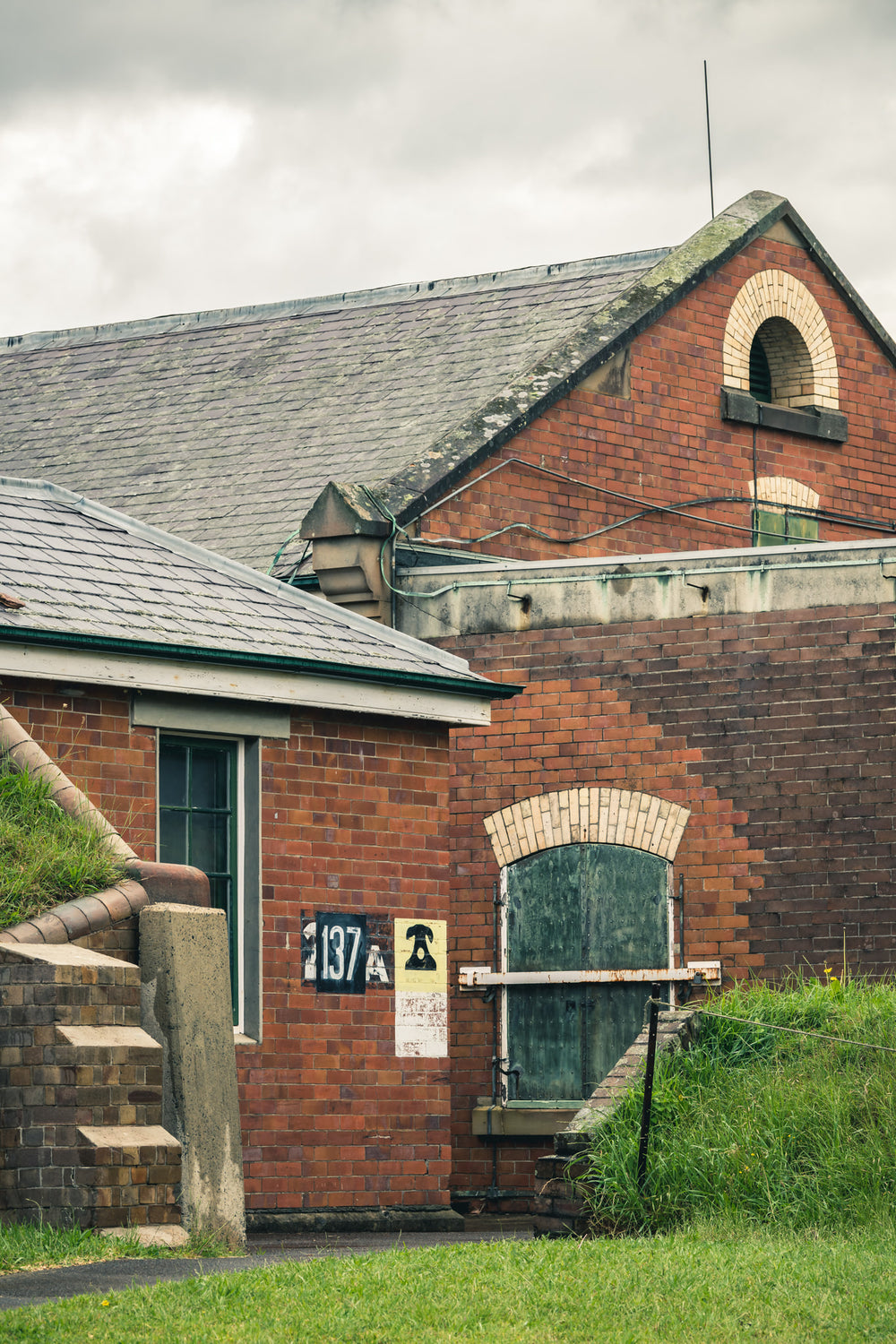 Building 137 at Newington Armory, red brick walls rise in two tiers.