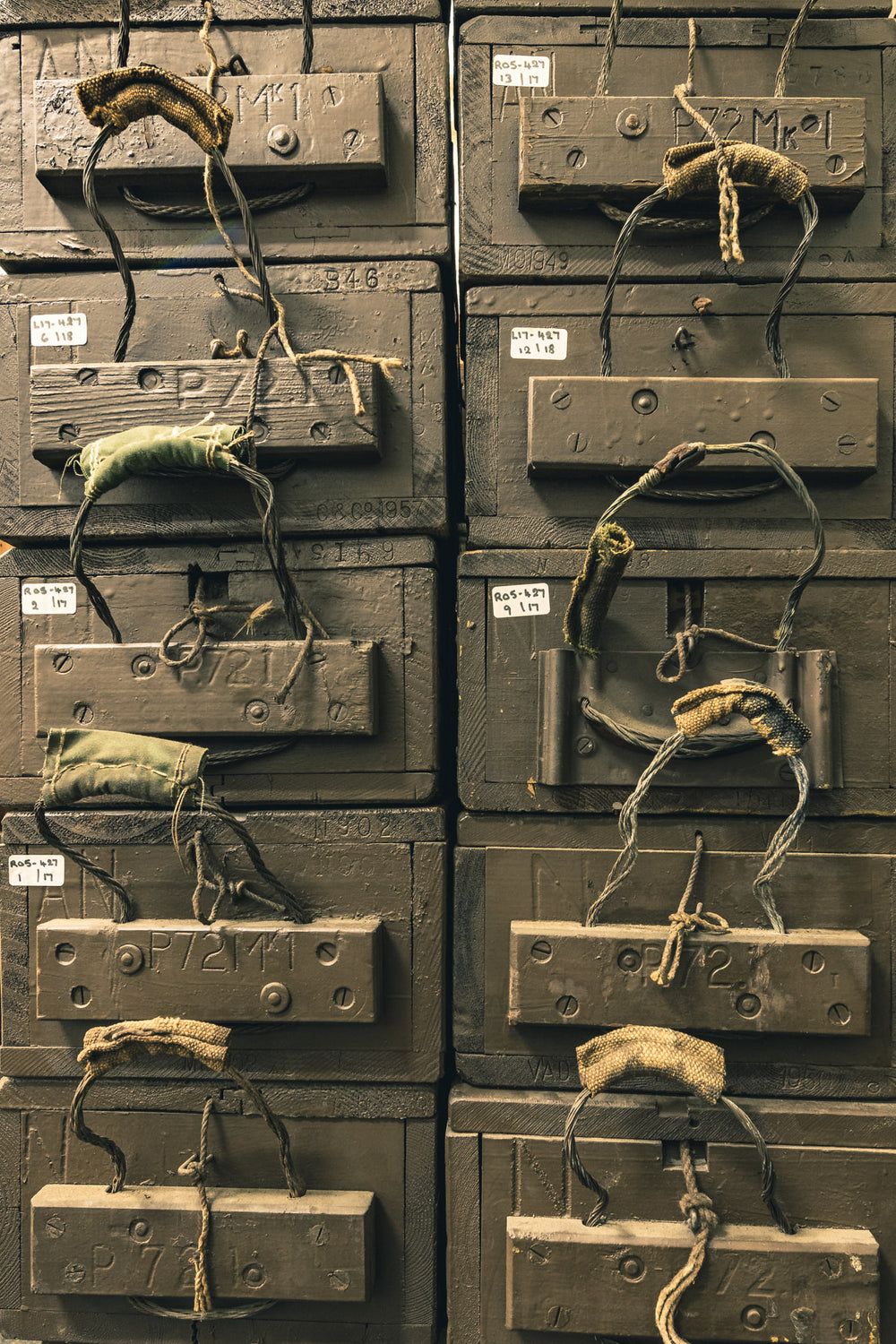 Crate Stack at Newington Armory, military ammunition crates stacked in two tight columns, olive-drab paint thick over heavy.