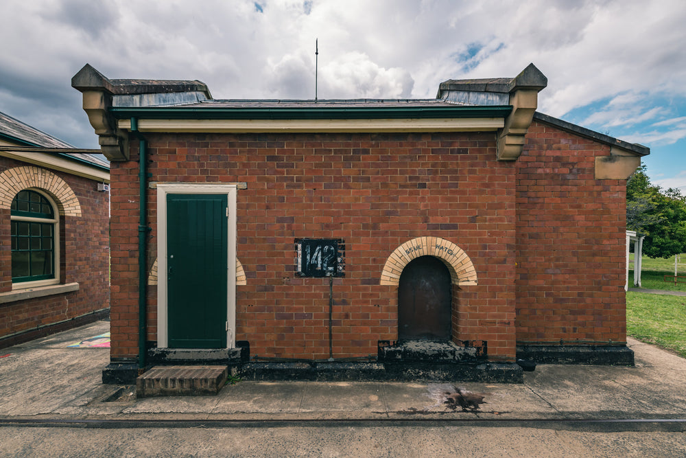 Issue Hatch at Newington Armory, a squat red-brick building sits square against a concrete apron.