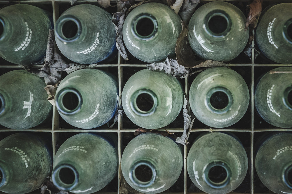 Bottles at Nichitsu Mining Village, a crate full of empty sake bottles awaiting the collection that never came.