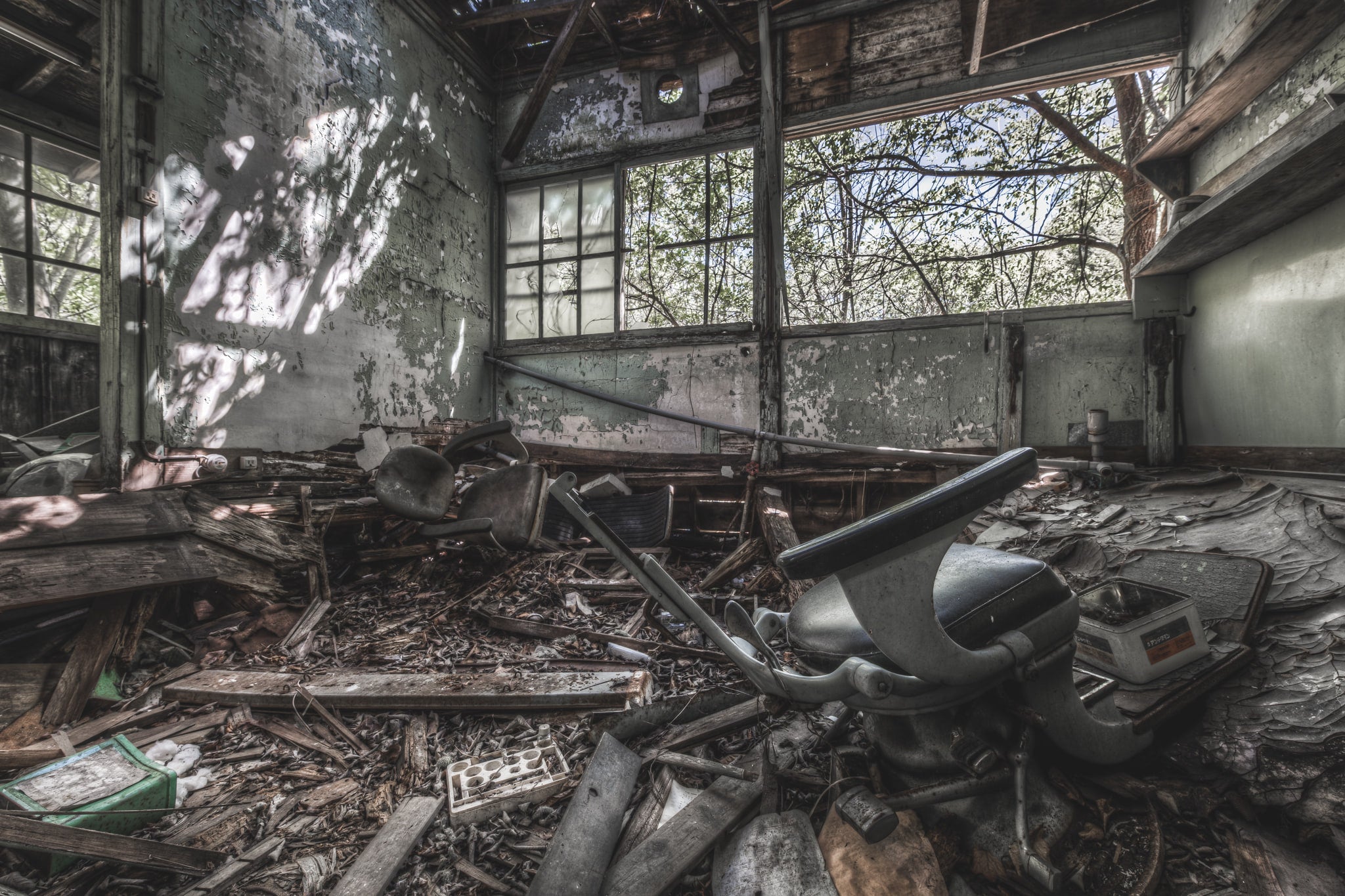 Dentist at Nichitsu Mining Village, a rusted dental chair stands amidst the decay of a forgotten office in Nichitsu Mining.