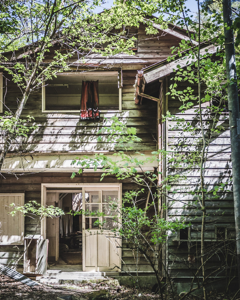 Entrance at Nichitsu Mining Village, the timber weatherboard facade of a communal building.