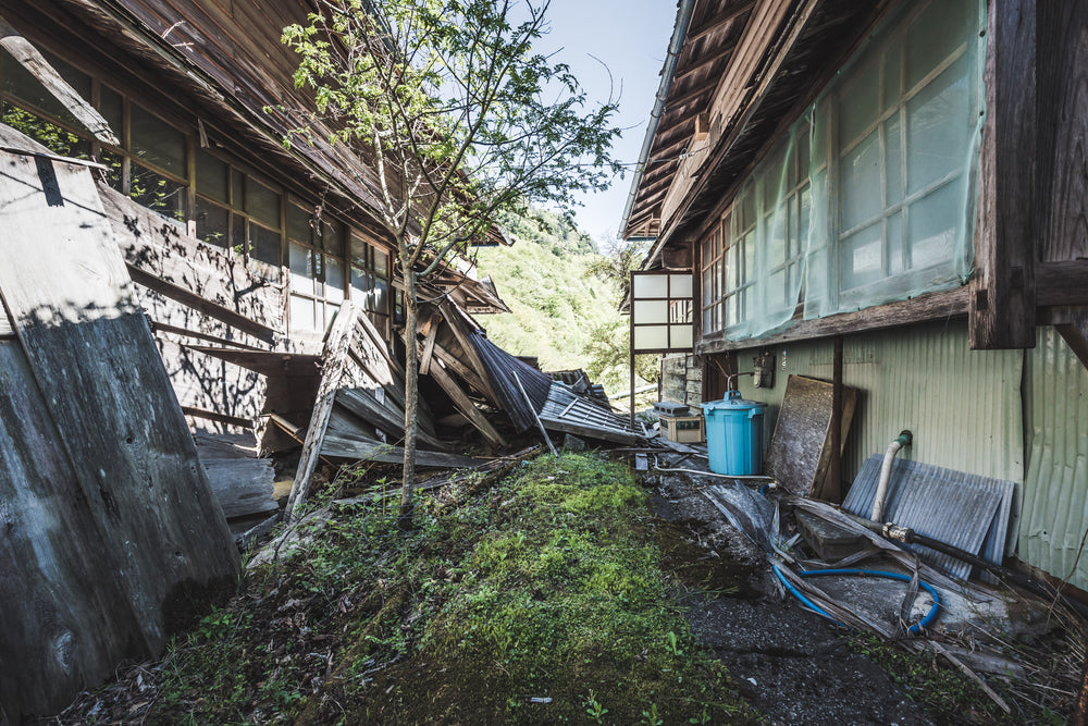 Living Quarters Alley at Nichitsu Mining Village, two wooden residential buildings lean toward each other across a narrow.