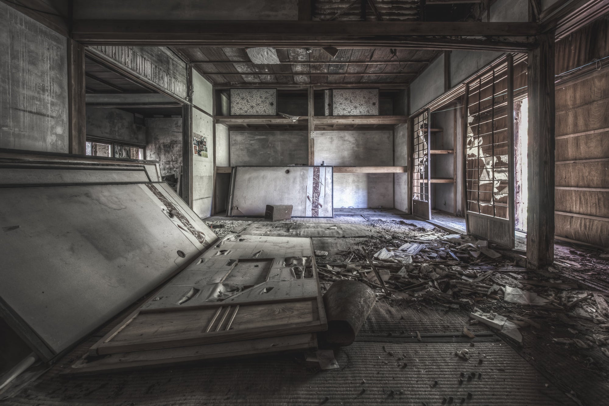 Living Quarters at Nichitsu Mining Village, a tatami room inside a collapsed Japanese dwelling.