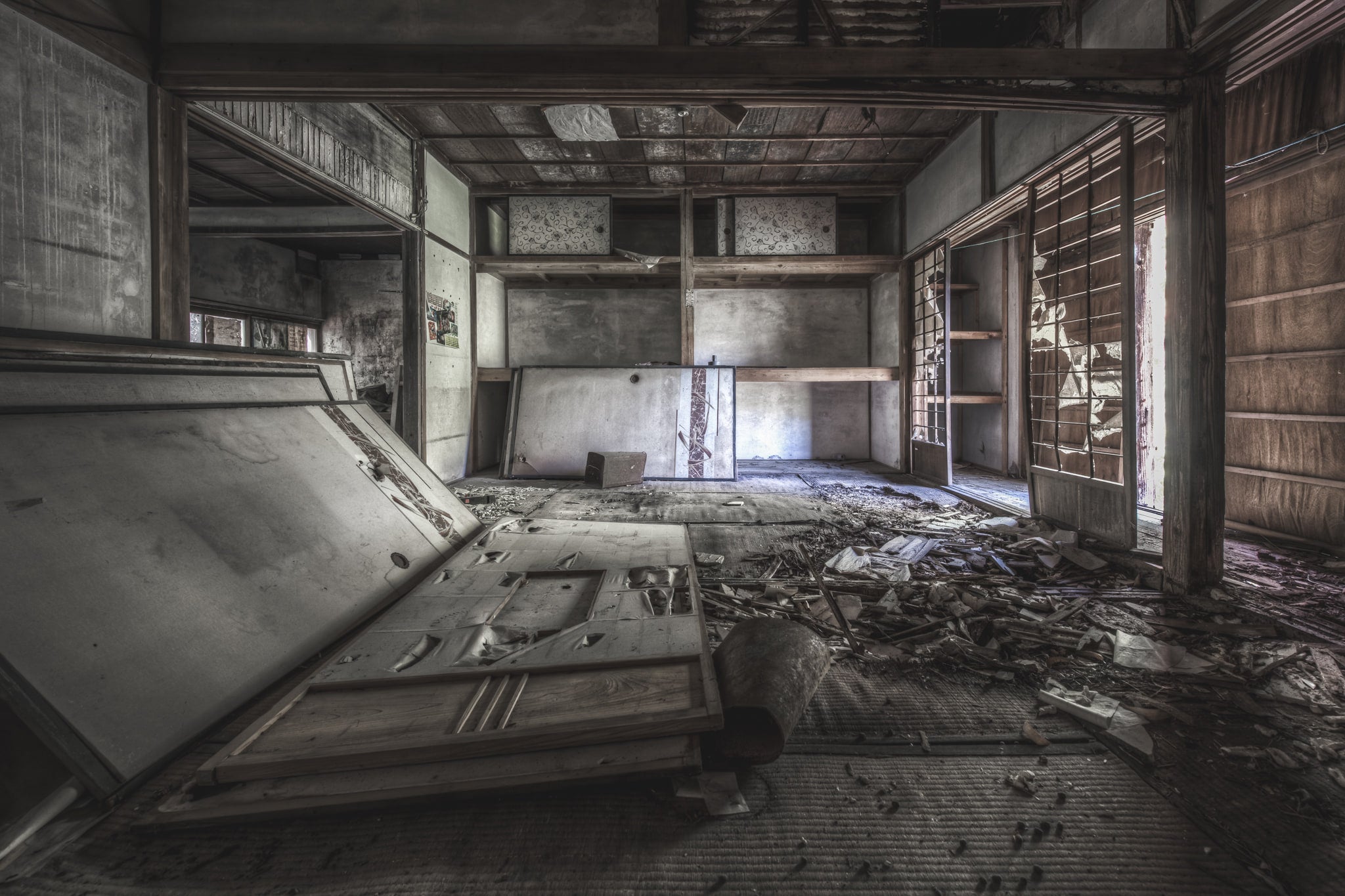 Living Quarters at Nichitsu Mining Village, a tatami room inside a collapsed Japanese dwelling.