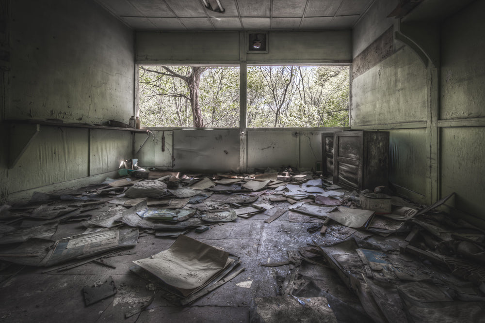 Storeroom at Nichitsu Mining Village, papers and folders cover every centimetre of the floor.