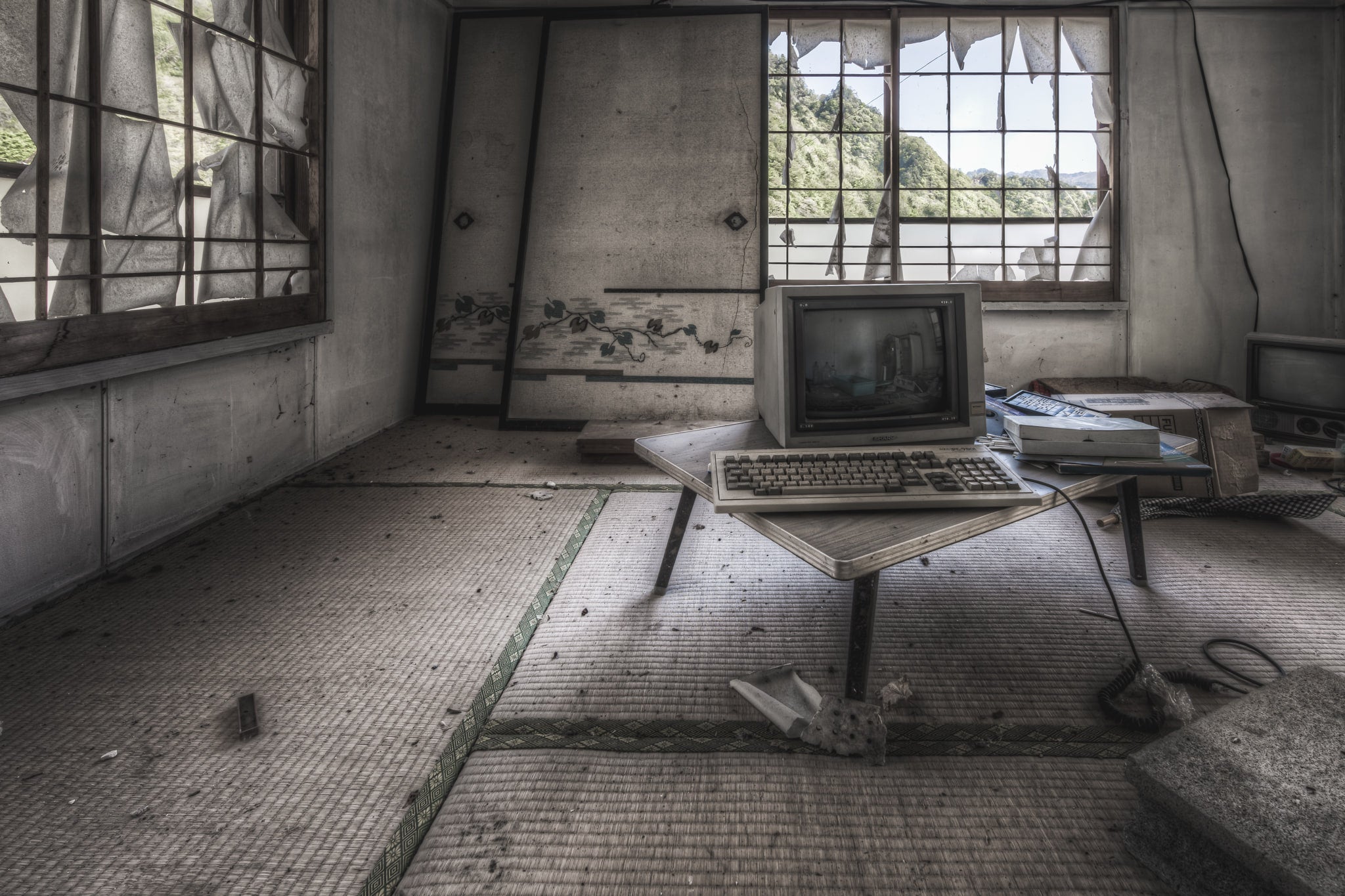 Study Room at Nichitsu Mining Village, an old computer in a decaying tatami mat floored room.