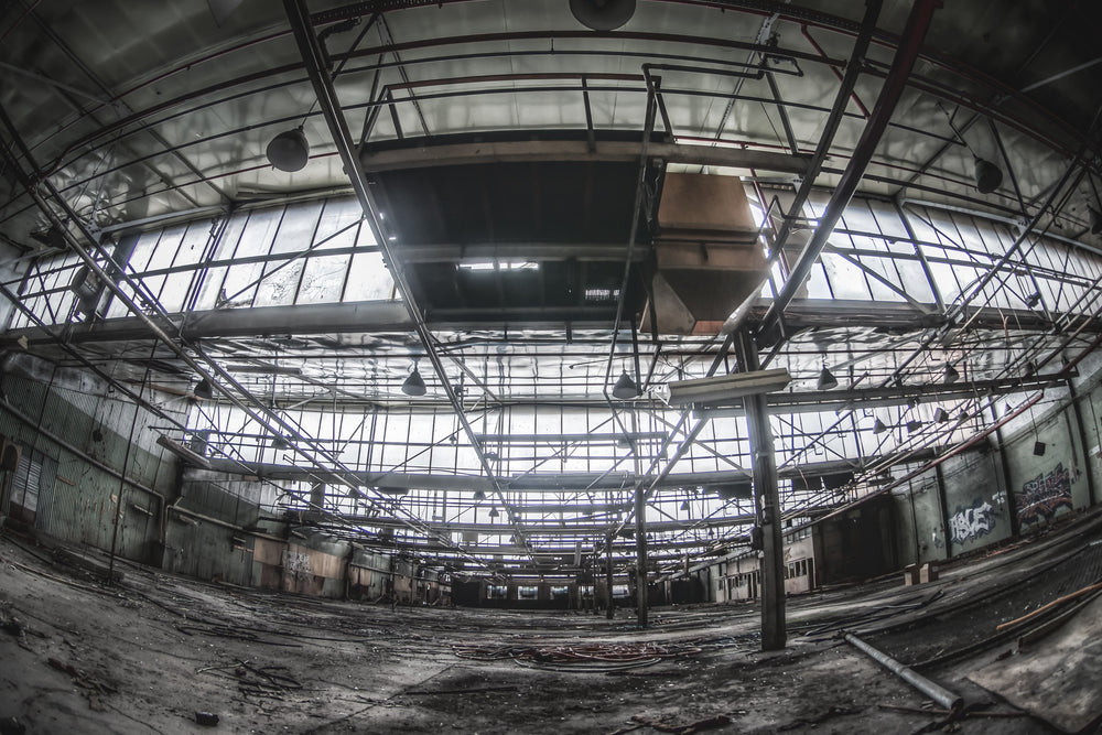 Closures Floor at O-I Glass, steel trusses span the full width of the closures floor, crossing high above a concrete slab.