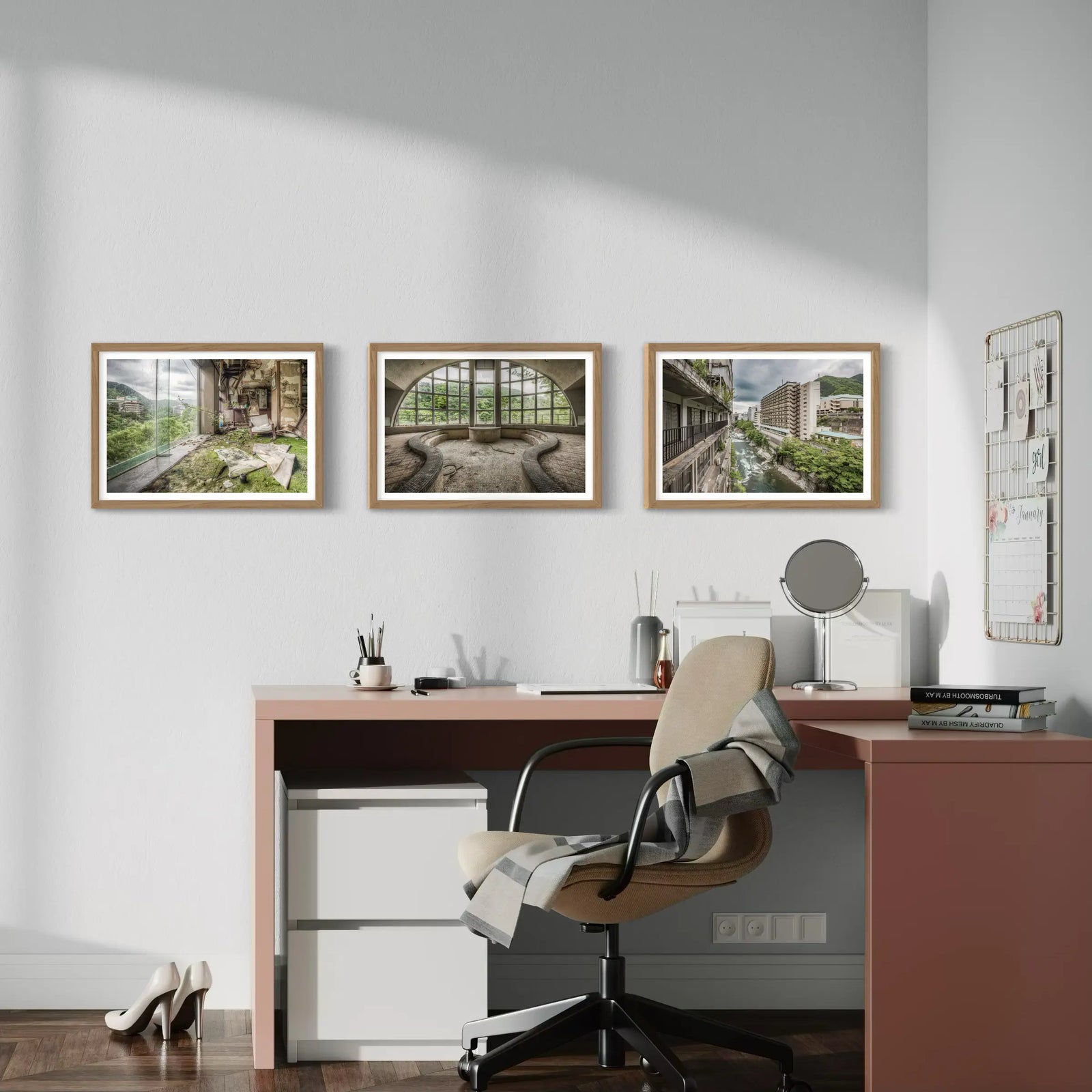 Modern home office with three framed art prints featuring abandoned buildings, industrial spaces, and serene landscapes.
