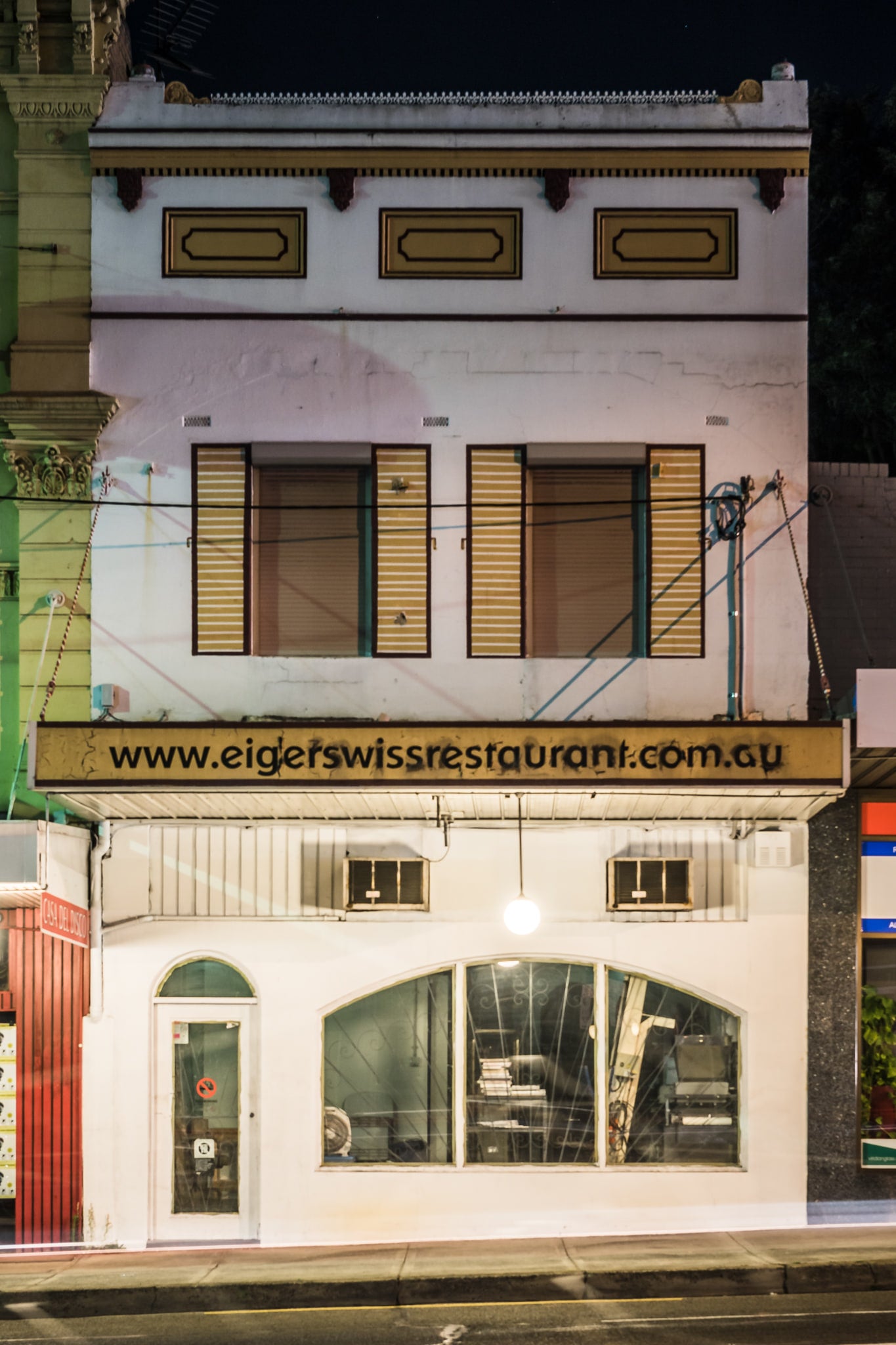 Eiger Swiss Restaurant at Parramatta Road, a two-storey Victorian-era shopfront sits flush with the footpath on Parramatta.