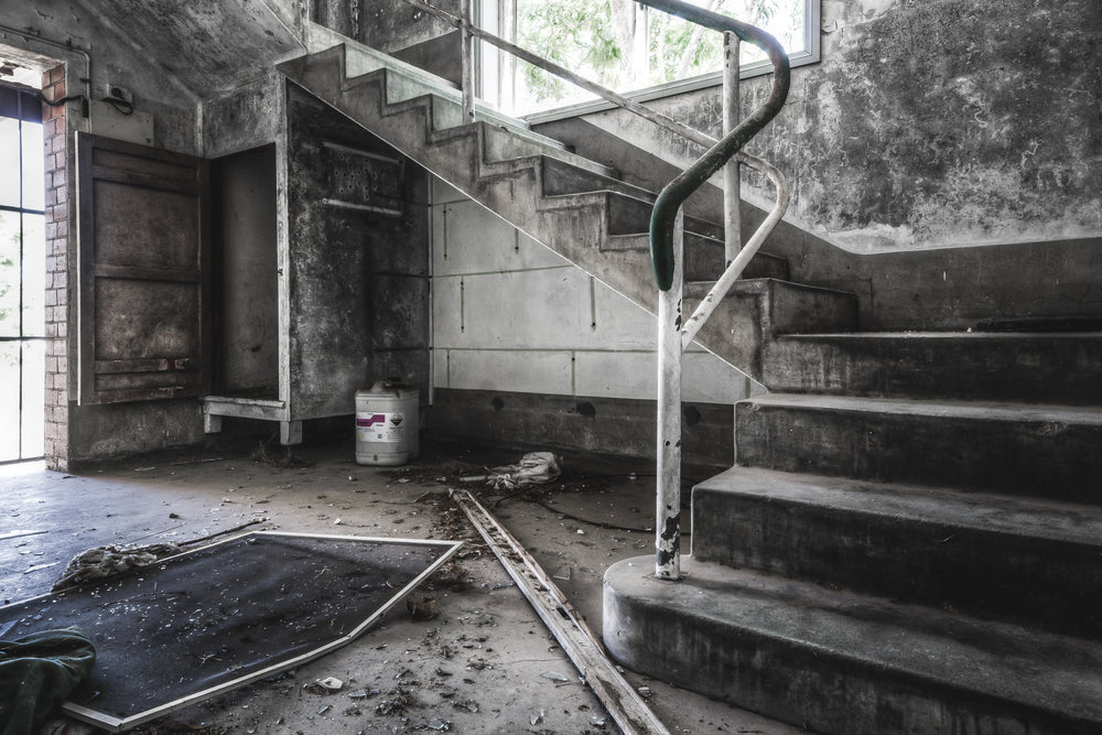 Amenities Block at Peters Ice Cream Factory, a concrete staircase turns at a landing between floors.