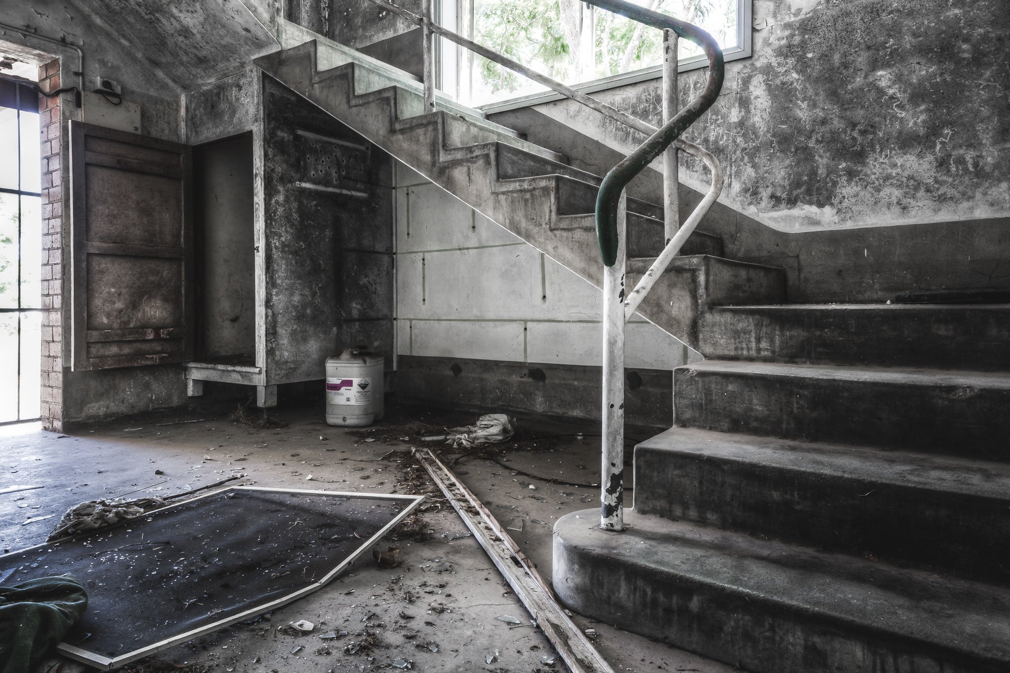 Amenities Block at Peters Ice Cream Factory, a concrete staircase turns at a landing between floors.
